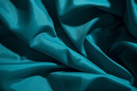 Background image of crumpled fabric. Blue silkの写真素材