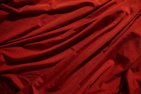 Background image of crumpled fabric. Red clothの写真素材