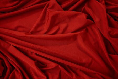 Background image of crumpled fabric. Red clothの写真素材