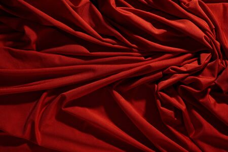 Background image of crumpled fabric. Red clothの写真素材