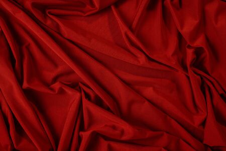 Background image of crumpled fabric. Red clothの写真素材