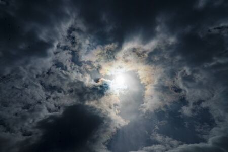 Background image of blue sky with clouds. Sunlight breaking through the cloudsの写真素材