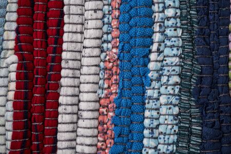 Texture of a multi-colored rug made from different fabricsの写真素材