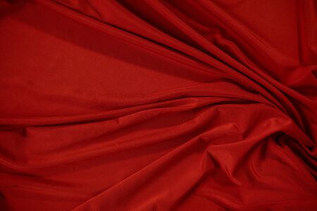Background image of crumpled fabric. Red clothの写真素材