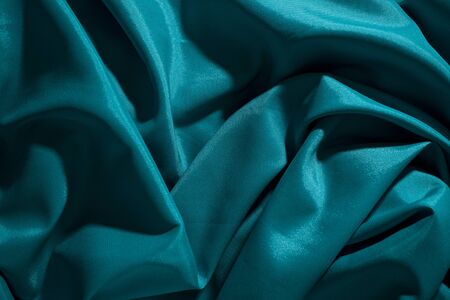 Background image of crumpled fabric. Blue silkの写真素材