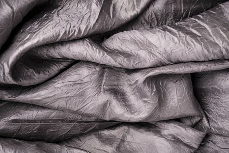 Background image of crumpled gray fabricの写真素材