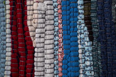 Texture of a multi-colored rug made from different fabricsの写真素材