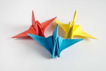 Photo of a cute crane made of paper. Beautiful origami. Close-up.