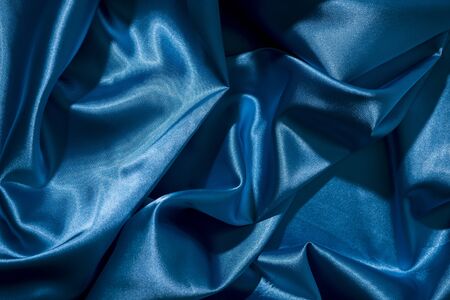 Background image of crumpled fabric. Blue silkの写真素材