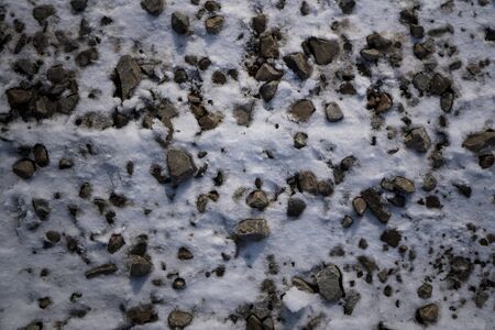 Gravel texture in the snow. Background image of stones in the snow.の写真素材
