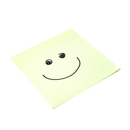 Paper sticker. Stylized image of the happy smiley character. Isolated sticker with shadow on a white background. Sticky note. A piece of paper for notes. Self-adhesive piece of paper.の写真素材