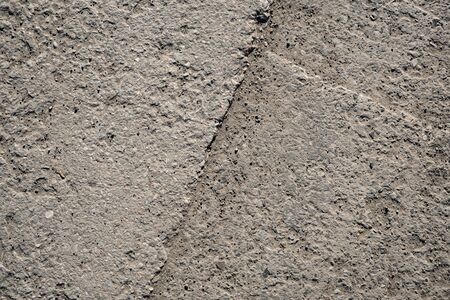 Detailed texture of concrete slab. Cracks in concrete. Old concrete pavement. Reinforced concrete...