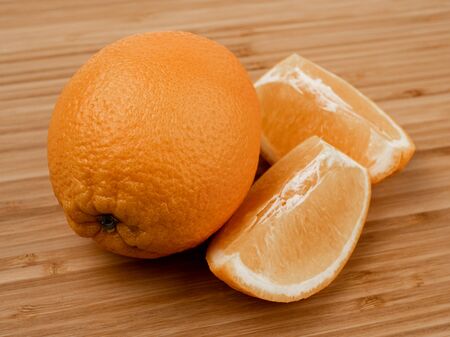 Orange on a wooden background. Wooden plank. Harvest fresh oranges. Ripe fruit. Wood texture. Orange peel. A slice of orange. Peeled orange. Vitamin C. Fruit diet. Background image of fruit.の写真素材