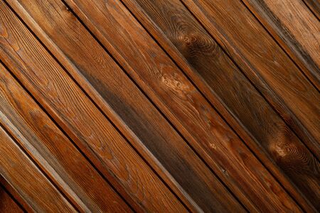Wood texture. Background image of a wooden wall. Exterior of a wooden house. Wooden lining. Space for text. Background for text. The joint of a wooden board. Top view. Lining impregnated with stain.の写真素材