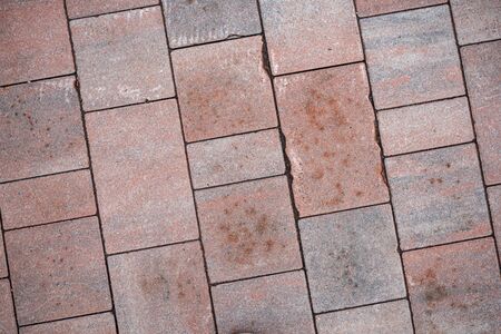 Background image of neatly laid paving slabs. Wallpaper. Substrate for text. Detailed texture of a tiled path. Paving slabs in the exterior. The surface of the road for pedestrians.の写真素材