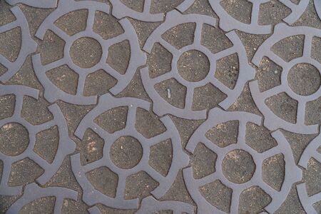 Background image of pavement surface. Wallpaper. Substrate for text. Detailed texture. Idea for exterior and interior. Geometric pattern. Metal gears.の写真素材