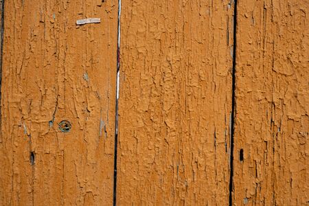 Background image of a wooden fence. Texture of painted wood. The texture of the old paint. Cracks in the paint. Wooden boards. Old fence painted with yolk paint. Text space. Wallpaper.の写真素材