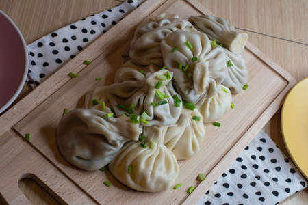 khinkali sprinkled with green onions on a wooden boardの写真素材