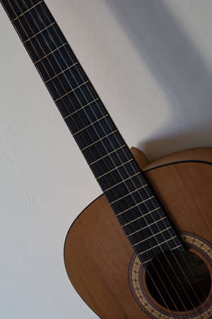 Acoustic guitar close up on white background