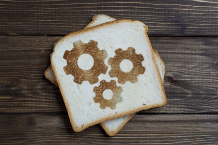 toast with a working gear sign on dark wood. teamwork. Interaction in the mechanism.の写真素材