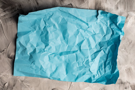 crumpled colored paper on gray concrete top viewの写真素材
