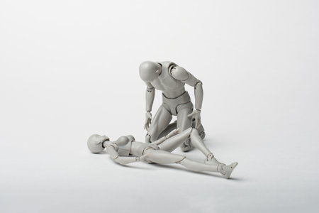 The male figurine bent over the recumbent body of the female figurine. Feel sorry for what you have done. Ask for forgiveness.の写真素材