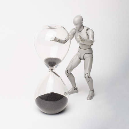 An attempt to stop time. Time spares none. Regret for the past. Time is running away like sand. The grief of lost time. Missed opportunities. The past cannot be returned.の写真素材