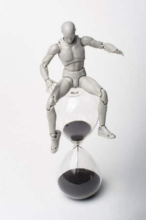 An attempt to stop time. Time spares none. Regret for the past. Time is running away like sand. The grief of lost time. Missed opportunities. The past cannot be returned.の写真素材