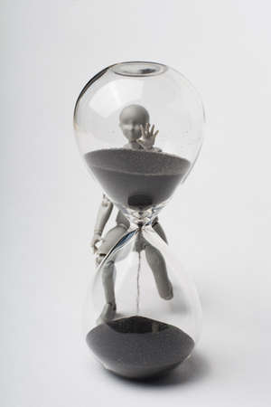 An attempt to stop time. Time spares none. Regret for the past. Time is running away like sand. The grief of lost time. Missed opportunities. The past cannot be returned.の写真素材