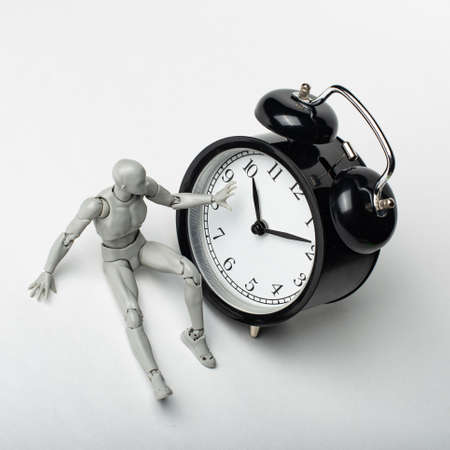 The man sits for hours. An attempt to stop time. The clock counts down the seconds.の写真素材