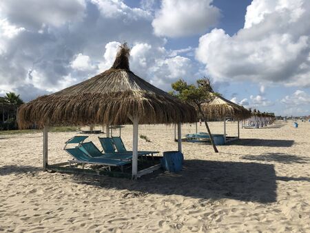 Beach Chairs and Umbrella on a beautiful bach in Durres, Albania.textの写真素材