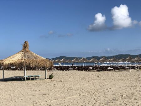 Beach Chairs and Umbrella on a beautiful bach in Durres, Albania.textの写真素材
