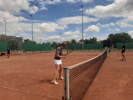 Tennis court Stadium red ground in sunset , clouds in the sky.のeditorial素材