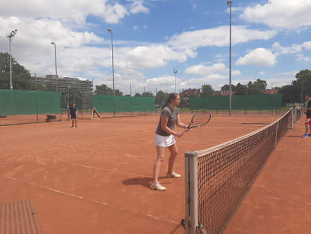 Tennis court Stadium red ground in sunset , clouds in the sky.のeditorial素材