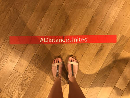 Top view female feet.Keep the distance sign on the ground.の写真素材