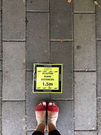 Top view female feet.Keep the distance sign on the ground.の写真素材