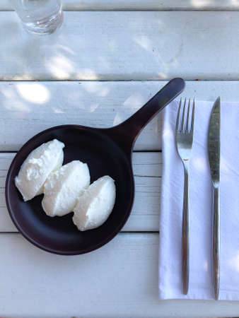 Top view of Curd cheese, ricotta, farmers cheese or tvorog in a wooden bowlの写真素材