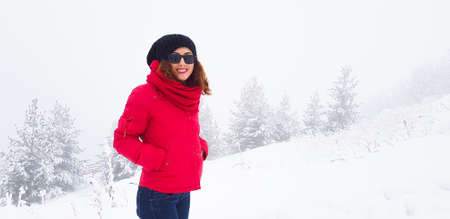 Lonely girl in the red coat posing on minimalist background,のeditorial素材