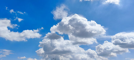 Blue sky background with white clouds. Cumulus white clouds in the blue sky.