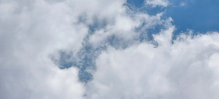 Blue sky background with white clouds. Cumulus white clouds in the blue sky.