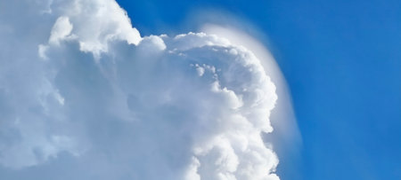 Blue sky background with white clouds. Cumulus white clouds in the blue sky.の写真素材