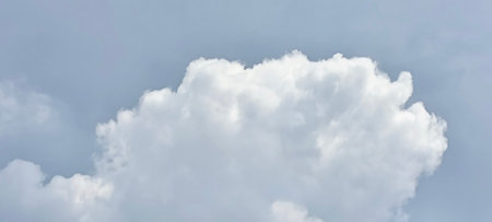 The vast blue sky and clouds form a beautiful background.