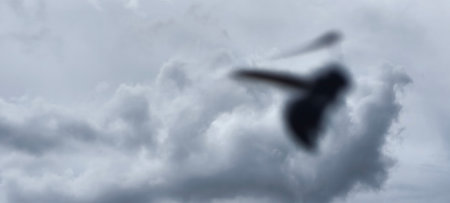 A silhouette of a man flying in the cloudy sky. 3d renderingの写真素材