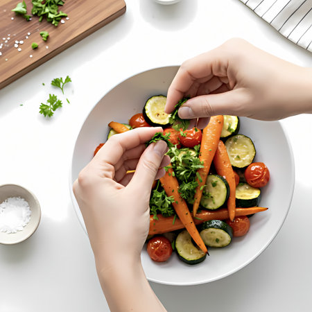 Woman's hands preparing vegetable salad on white background, top view.の素材