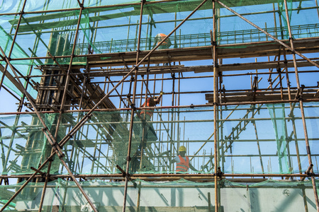 Scaffolding of construction site, blue sky background
