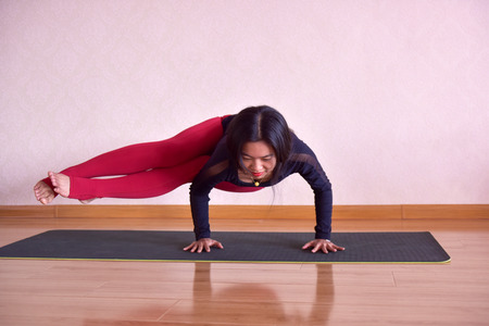 A Chinese beauty performs beautiful yoga exercises indoors. November 18, 2018, photo taken at Bodhi yoga hall, Luannan County, Tangshan ity,Hebei, China.のeditorial素材
