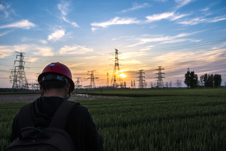 Electric power workers work on tower sites