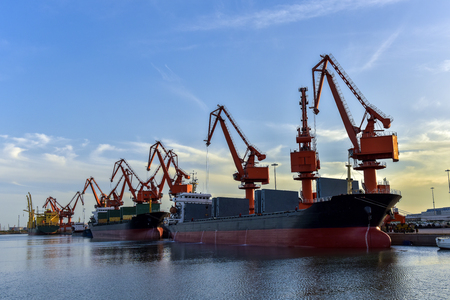 Heavy Loader Working in a Harbour in the Background of Sunsetの写真素材
