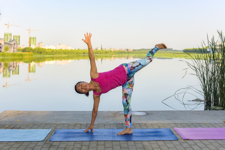 Luannan County, Hebei Province, China - September 1, 2019. The concept of healthy lifestyle for fitness women doing yoga exercises and relaxation and sportswear in green parks in summerのeditorial素材