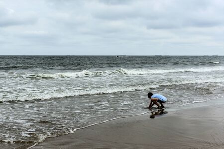 Coastline in the background of dark cloudsの写真素材